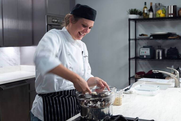 Pastry chef at a stove making fudge