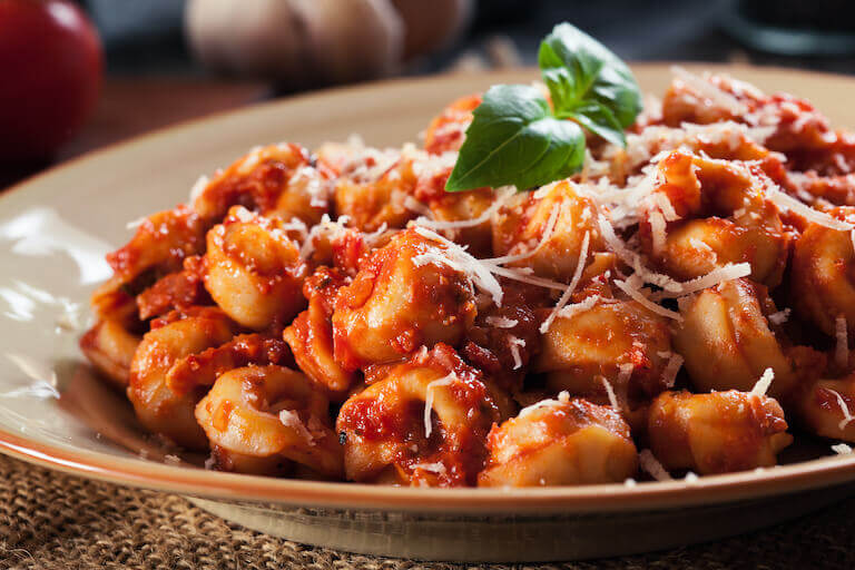 Tortellini covered in tomato sauce